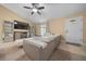 Living room with L-shaped sofa, TV, and ceiling fan at 16867 Sw 40Th Cir, Ocala, FL 34473