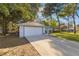 Light blue house with a white garage door and long driveway at 2340 Ne 43Rd St, Ocala, FL 34479