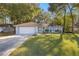 Cute light blue house with a white garage door and green lawn at 2340 Ne 43Rd St, Ocala, FL 34479