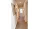 Bright hallway with neutral walls and doors to bedrooms at 25 Nw 113Th Cir, Ocala, FL 34482