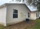 Exterior view of the home showing the siding, roof, and the surrounding yard at 2611 Hialeah Ave, The Villages, FL 32162