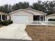 Charming single-story home featuring a one-car garage and a cozy, white picket fence at 2611 Hialeah Ave, The Villages, FL 32162