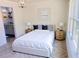Tastefully decorated bedroom with Herringbone floors and views to ensuite bath at 2881 Se 140Th Pl, Summerfield, FL 34491
