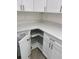 Well-organized kitchen storage featuring white cabinets, quartz counters, and a lazy susan at 2881 Se 140Th Pl, Summerfield, FL 34491