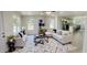 Bright living room featuring contemporary furnishings, large windows, and an open concept kitchen providing ample space at 2881 Se 140Th Pl, Summerfield, FL 34491