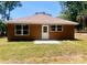 The back exterior of the home, featuring a neutral color scheme and a small, freshly laid back patio at 2998 Se 140Th Ln, Summerfield, FL 34491