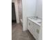 Bathroom featuring a dual sink vanity with white cabinets and quartz countertop at 2998 Se 140Th Ln, Summerfield, FL 34491