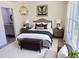Stylishly staged bedroom featuring a king-sized bed, wing art and a contemporary chandelier at 2998 Se 140Th Ln, Summerfield, FL 34491