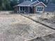 New construction showcasing the home's exterior, situated on a spacious lot with a partially constructed patio at 2998 Se 140Th Ln, Summerfield, FL 34491