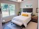 Bright main bedroom with large window, modern decor, and comfortable furnishings at 2998 Se 140Th Ln, Summerfield, FL 34491