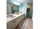 Double vanity bathroom with light teal walls and tile flooring at 3 Maple Run, Ocala, FL 34472