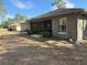 Back of house with screened porch and yard at 3 Maple Run, Ocala, FL 34472