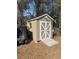 Tan storage shed with white doors and ramp at 3 Maple Run, Ocala, FL 34472