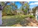 Large backyard with lush grass and trees at 3650 Se 22Nd Ave, Ocala, FL 34471