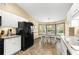 Galley kitchen with ample counter space, white cabinets, and black appliances at 3650 Se 22Nd Ave, Ocala, FL 34471