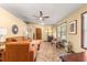 Living area with orange couch, a ceiling fan, and view of kitchen at 3650 Se 22Nd Ave, Ocala, FL 34471