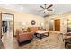 Open living room features a view into the kitchen and a ceiling fan at 3650 Se 22Nd Ave, Ocala, FL 34471