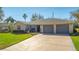 Single-story home with stone accents, two-car garage, and landscaped yard at 3660 Se 54Th Ave, Ocala, FL 34480