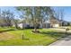 Landscaped front yard with a large tree and spacious driveway at 3660 Se 54Th Ave, Ocala, FL 34480