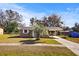 Front view of a tan house with a carport and palm tree at 3766 Sw 147Th Lane Rd, Ocala, FL 34473