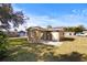 Rear view of a tan house with sliding glass doors at 3766 Sw 147Th Lane Rd, Ocala, FL 34473