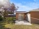 Backyard view of a tan house with sliding glass doors and shed at 3766 Sw 147Th Lane Rd, Ocala, FL 34473