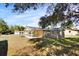 Side view of a tan house with covered patio and fenced yard at 3766 Sw 147Th Lane Rd, Ocala, FL 34473