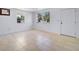 Living room with light beige tile flooring and two windows at 3766 Sw 147Th Lane Rd, Ocala, FL 34473