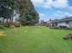 Large backyard with lush lawn and landscaping at 3805 Se 138Th Pl, Summerfield, FL 34491