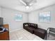 Bright bedroom with tiled floors and a brown sofa at 3805 Se 138Th Pl, Summerfield, FL 34491