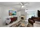 Bright living room featuring fireplace and open floor plan at 3805 Se 138Th Pl, Summerfield, FL 34491