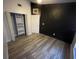 Bedroom with dark accent wall and wood-look floors at 4503 Oak Arbor Cir, Orlando, FL 32808