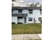 Light blue two-story townhome with a gray door and manicured lawn at 4503 Oak Arbor Cir, Orlando, FL 32808