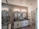 Elegant bathroom with double vanity, large mirrors, and separate toilet at 4709 Se 25Th Loop, Ocala, FL 34480