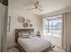 Cozy bedroom featuring a queen bed and large window at 4709 Se 25Th Loop, Ocala, FL 34480