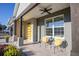 Front porch with yellow door, ceiling fan, and two comfy chairs at 4709 Se 25Th Loop, Ocala, FL 34480