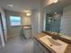 Bright bathroom boasts double sinks, a large mirror, and a walk-in shower at 5110 Sw 92Nd St, Ocala, FL 34476