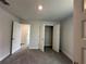 Well-lit bedroom with double door closet and carpet flooring at 5110 Sw 92Nd St, Ocala, FL 34476