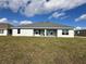 Rear view of a single-story home with covered patio at 5110 Sw 92Nd St, Ocala, FL 34476