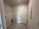 Laundry room with built-in shelving and door to outside at 5110 Sw 92Nd St, Ocala, FL 34476