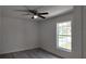 Bright bedroom features wood-look flooring, a ceiling fan, and a window letting in natural light at 5363 Nw 3Rd St, Ocala, FL 34482