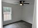 Well-lit bedroom featuring a window, ceiling fan, and wood-look flooring at 5363 Nw 3Rd St, Ocala, FL 34482