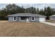 Newly constructed home with gray siding, a white door, and a driveway at 5363 Nw 3Rd St, Ocala, FL 34482