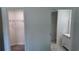 Hallway view showcasing a walk-in closet and the bathroom, seamlessly blending functionality with modern design at 5363 Nw 3Rd St, Ocala, FL 34482