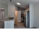 Bright kitchen featuring stainless steel appliances, granite countertops, and a convenient pantry for ample storage at 5363 Nw 3Rd St, Ocala, FL 34482