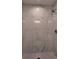 Luxurious shower featuring marble-look tile walls and a modern showerhead, creating a spa-like experience at 5363 Nw 3Rd St, Ocala, FL 34482