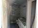 Stylish bathroom with marble-look tile in shower, double vanity, granite countertop, and modern fixtures at 5411 Nw 7Th Pl, Ocala, FL 34482
