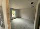 Bright bedroom featuring unfinished walls, a window, and ample natural light at 5411 Nw 7Th Pl, Ocala, FL 34482