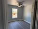 Cozy bedroom with a ceiling fan, natural light and modern floors at 5411 Nw 7Th Pl, Ocala, FL 34482