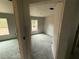 Bright bedroom with window and unfinished walls and flooring at 5411 Nw 7Th Pl, Ocala, FL 34482